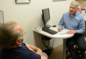 Spine orthopedic surgeon explaining treatment options to a patient