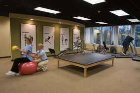 Spine therapy gym with a physical therapist helping a patient