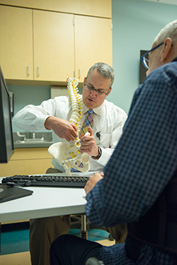 Spine orthopedic surgeon explaining treatment options to a patient
