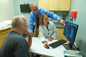 Spine orthopedic surgeon explaining treatment options to a patient